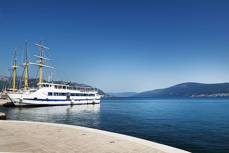 White ship on the background of the blue sea, sky and mountains. Toning. Soft focus.の写真素材