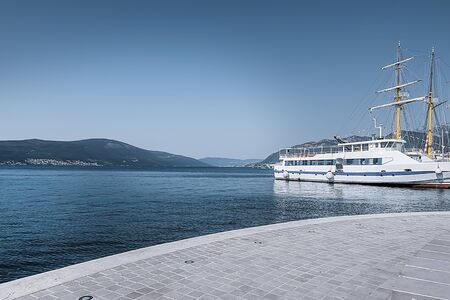 White ship on the background of the sea, sky and mountains. Toning. Soft focus.の写真素材