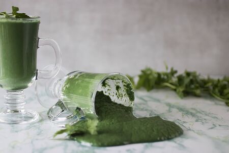 Green spirulina smoothie in glass cups on marble table. Superfood concept. Soft focus.の写真素材
