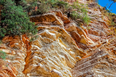 Beautiful layered cliffs on a background of blue sky. Soft focus.