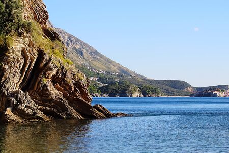 Beautiful layered cliffs on a background of blue sea. Soft focus.の写真素材