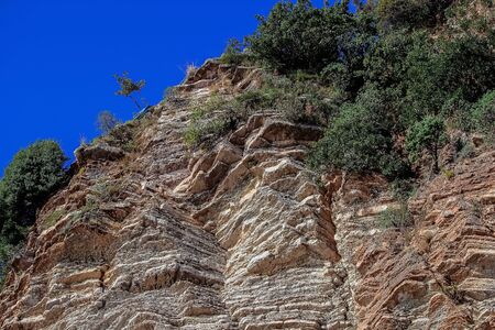 Beautiful layered cliffs on a background of blue sky. Soft focus.の写真素材