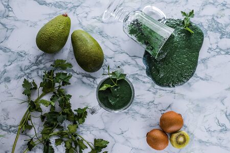Green smoothie  with  spirulina in glass cups on a marble table. Superfood concept. Top view. Soft focus.の写真素材