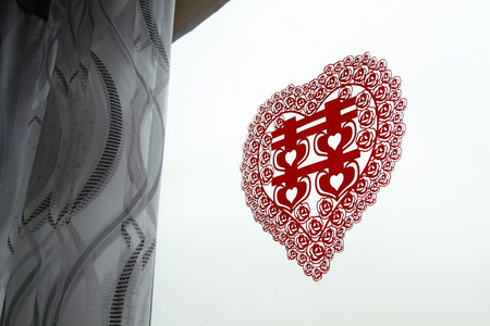 Red Chinese paper cut on windowの写真素材