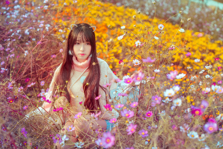 A girl surrounded by flowersの写真素材