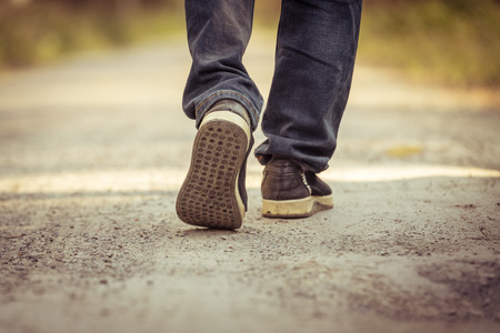 A man walks on the roadの写真素材