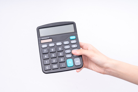 Hand holding a calculatorの写真素材