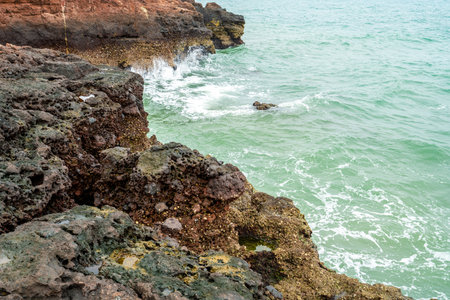 Volcanic rocks and reefs on the coastの写真素材
