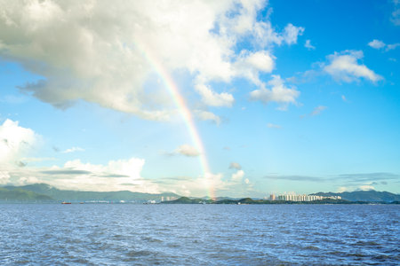 A rainbow in the blue sky after rainの写真素材