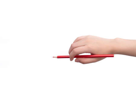 Hand holding pencil against white backgroundの写真素材