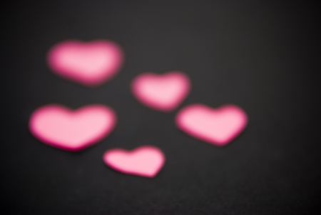 group of pink hearts on black background , blurredの写真素材