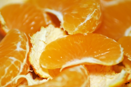 whole mandarin orange segments on with serving of lemonの写真素材