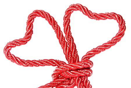 Red heart with knot on white backgroundの写真素材