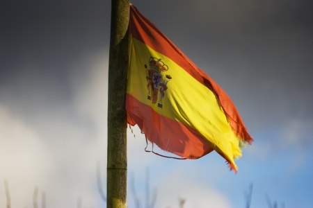 Flag of Spain worn , still waving , stormの写真素材