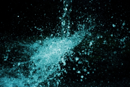 stream of water falling down on black backgroundの写真素材