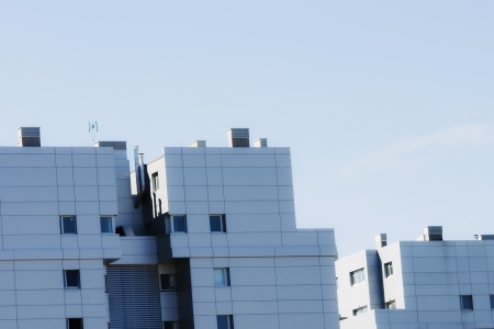 facade of a modern building with cloudy skyの写真素材