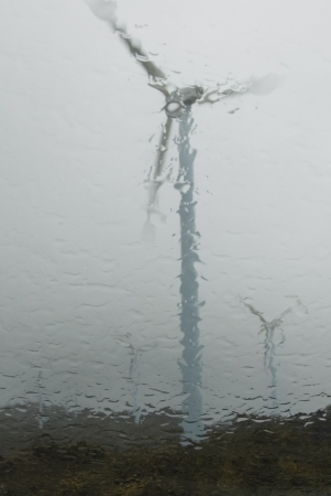 windmills through a glass a rainy dayの写真素材