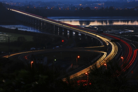 bridge over the river and car headlightsの写真素材