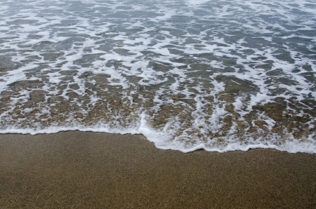 detail of the sand and sea water on a beachの写真素材