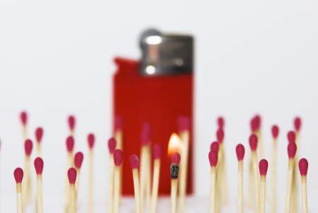 Group of matches versus a lighter redの写真素材