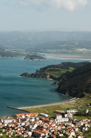 Coastal landscape with village and mountains in the backgroundの写真素材