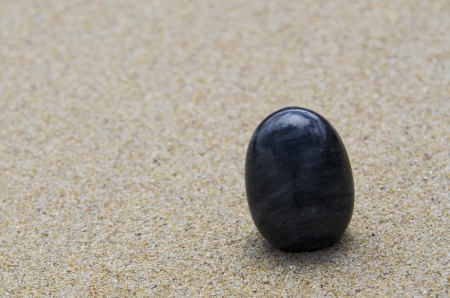 polished stones of different colors at the beachの写真素材
