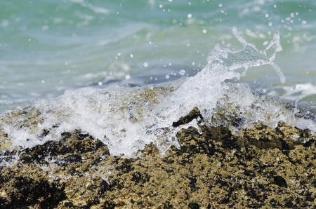 detail of the waves crashing against the rocks of the coastの写真素材