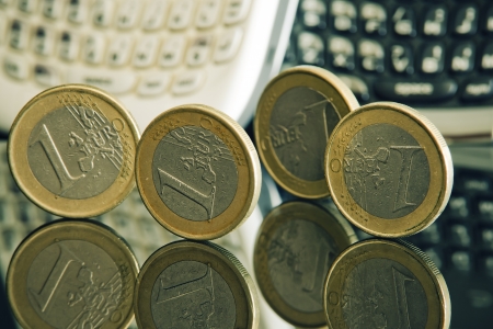 euro coins and mobile phones, telephony spending conceptの写真素材
