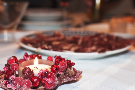 A nice candle on a dinner table during Christmas Eveの写真素材