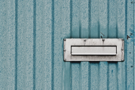 mailbox in the steel door with vertical barsの写真素材