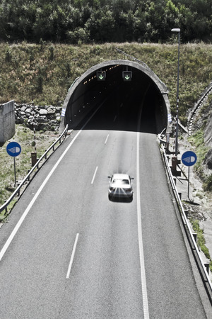 cars circulating in the entrance of the tunnel on the highwayの写真素材