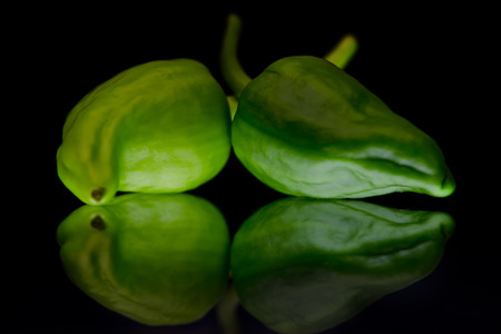 Green peppers on black background.の写真素材