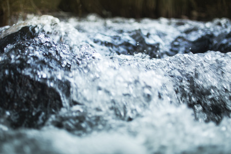 A river flows through the woods of Spain, slow shutterの写真素材