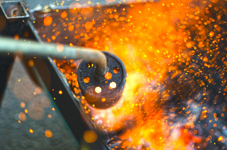 Ignition of the coal with a blowpipeの写真素材