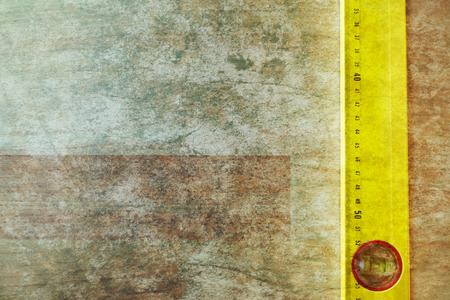 yellow construction level on woodの写真素材