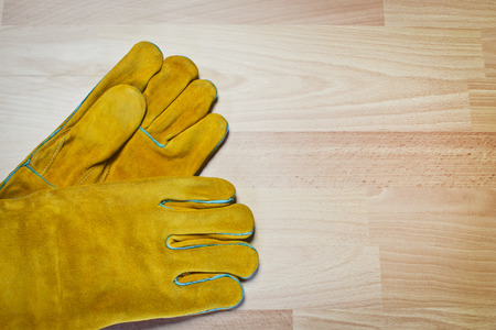Pair of work gloves on wooden surfaceの写真素材
