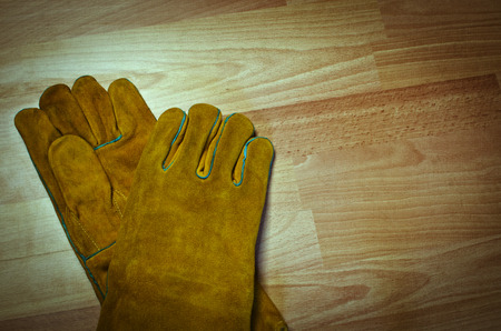 Pair of work gloves on wooden surfaceの写真素材