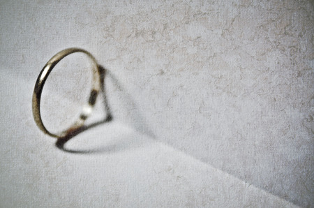 Wedding ring heart shadow casting on open pageの写真素材