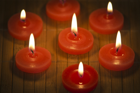 A burning flame of a candle of red color.の写真素材