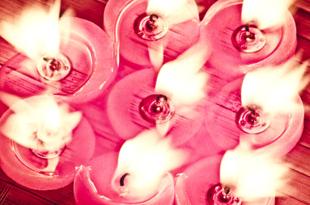 A burning flame of a candle of red color.の写真素材