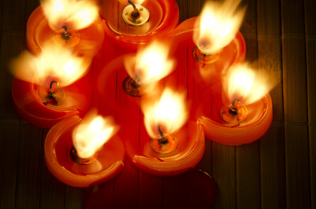 A burning flame of a candle of red color.の写真素材