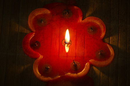 A burning flame of a candle of red color.の写真素材