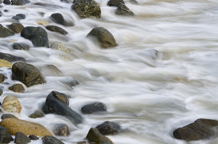 Water waves on rocks at a beachの写真素材