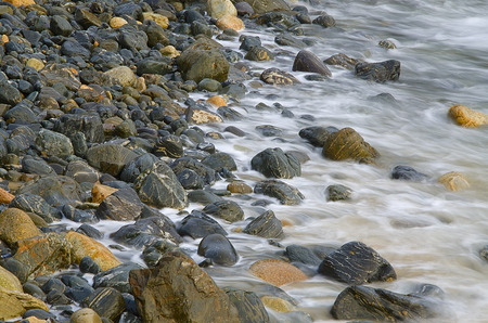 Water waves on rocks at a beachの写真素材