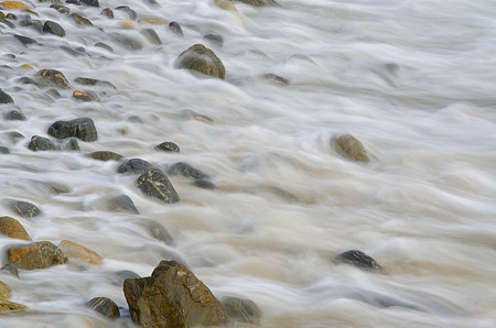 Water waves on rocks at a beachの写真素材