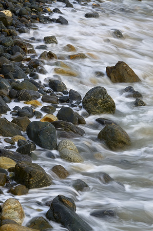 Water waves on rocks at a beachの写真素材