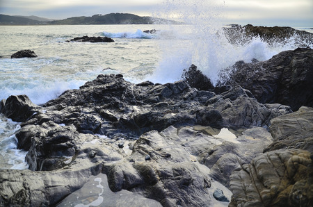 Water waves on rocks at a beachの写真素材
