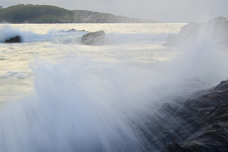 small waves breaking on the beachの写真素材