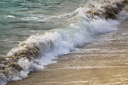 small waves breaking on the beachの写真素材