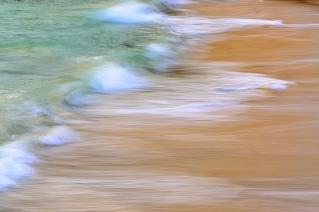small waves breaking on the beachの写真素材